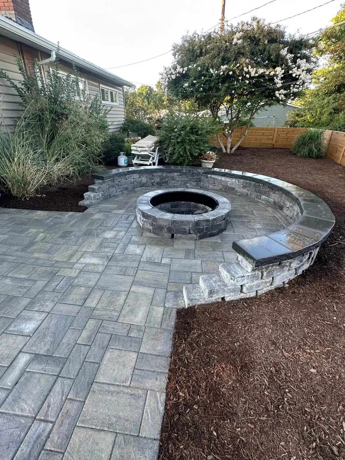 Custom Fire Pit with Seat Wall - Northwood Landscaping project in Greater Vancouver