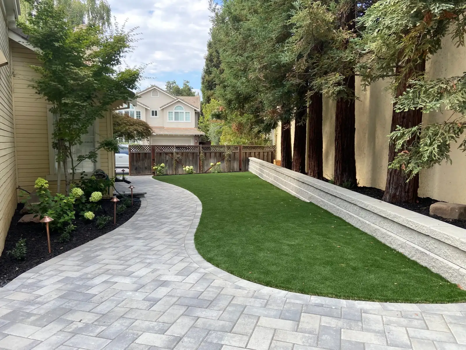 Paver walkway with artificial turf borders in Greater Vancouver