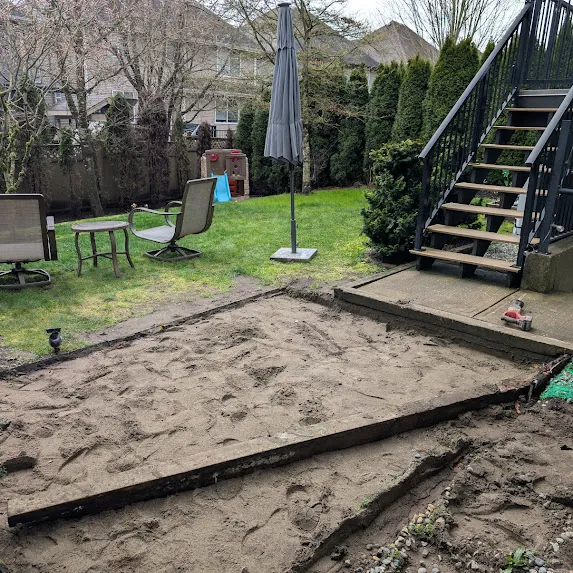 Before: bare dirt patio area awaiting landscaping